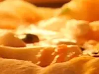 A pizza cooking in the Kalamazoo Outdoor Gourmet Artisan Fire Pizza Oven