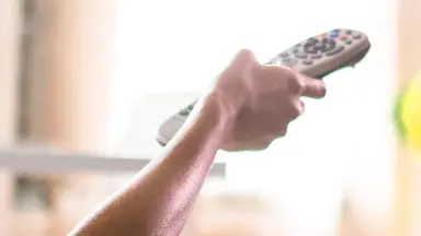 Woman watches cable TV