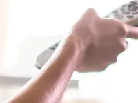 Woman watches cable TV