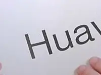 A Reviewed.com staffer holding a sign with a brand name