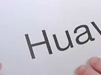 A Reviewed.com staffer holding a sign with a brand name