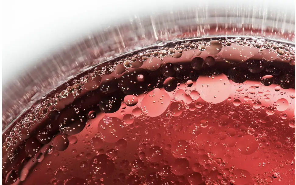A close-up of a red liquid being cooked