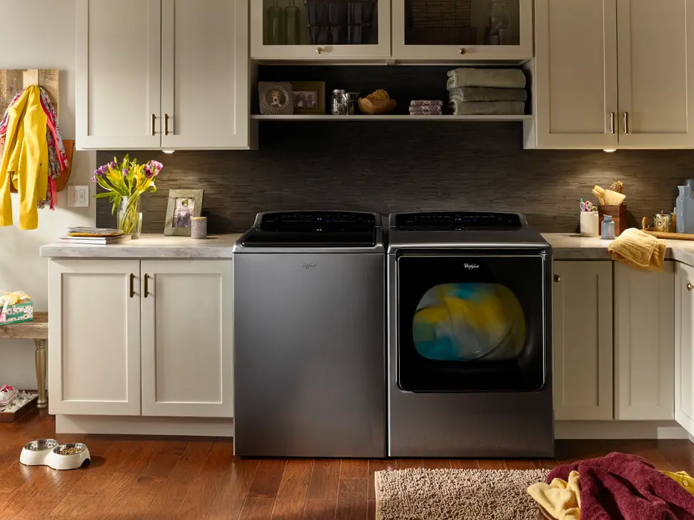Whirlpool smart top load laundry pair in a laundry room