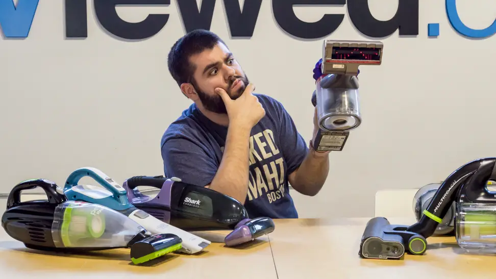 Picture of  man trying to figure out how vacuums work