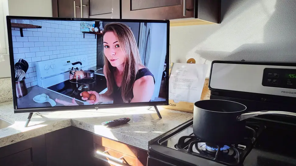 The TCL 3-Series, sitting in a kitchen, playing cooking content on YouTube