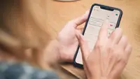 A person's hands holding a smartphone