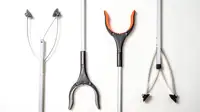 Four different reacher grabber tools on a white background