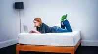 A woman lies on the leesa hybrid mattress