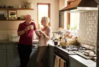 A senior couple in their kitchen at home