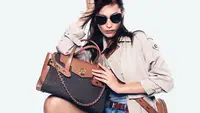Woman holding Michael Kors bag