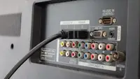 An HDMI cable plugged into a TV's ports