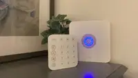 The Ring Alarm System keypad and home base station sit on a grey stand.