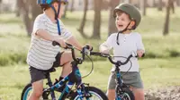Two children laugh as they sit on their Guardian Kids Bikes