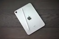 An Apple iPad Mini 6th-gen with Apple Pencil laid on top of it.