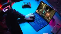 A person plays a PC game on a laptop