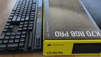A keyboard next to its packaging box