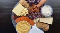 A photo of a vegan cheese board, on a marble slab, shot from above