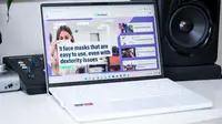 An open and powered on laptop sitting on a desk
