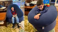 Boy lounges on a Yogibo bean bag.