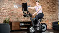 A woman riding the Echelon EX-8s exercise bike.