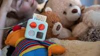 The Yoto Mini on a bed of cute stuffed animals.