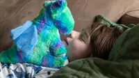 A child goes nose-to-nose with a dragon Warmie