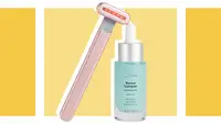 Red light therapy wand next to bottle of skin serum.