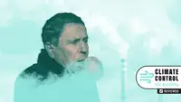 A white man coughs into his fist as smoke rises around him