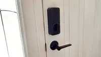 Close up of a door with a smart lock equipped.