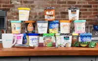 Pints of dairy free ice cream stacked on top of each other.