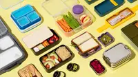 An assortment of bento boxes filled with vegetables, sandwiches, salad, and other food.