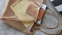 A beach bag being used to store items for a beach trip.