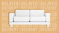 White sofa couch in front of "delayed delivery" phrase.