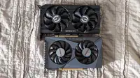 The Nvidia GeForce RTX 3050 and the AMD Radeon RX 6500 XT laying flat on a sheet.