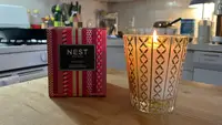 The Nest holiday candle on a kitchen counter.