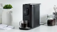 Product shot of the Instant Dual Pod Plus Coffee Maker on granite countertop in kitchen.