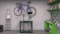 Garden tools and a bike hanging from an organizer.