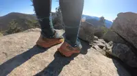 A hiker wearing a pair of Hoka running shoes