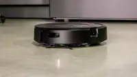 The iRobot j7+ Combo robot vacuum cleans a kitchen floor.