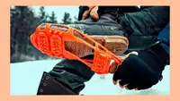 A person puts cleats on their winter boots outside.
