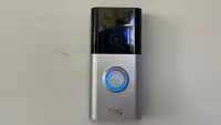 Ring Battery Doorbell Plus hanging on a front door