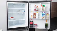 GE GDE25EYKFS Bottom-freezer Refrigerator open to show the spacious interior and door storage.