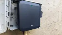 Moen Smart Sprinkler Controller attached to control box on exterior wall.