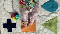 Baby legs on a KiwiCo playmat