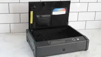 The Lockly Smart Safe with the lid open on a marble counter.