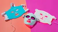 Three red light LED therapy masks on a pink background