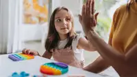 Child giving a high-five to a adult
