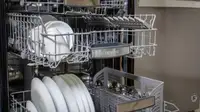 A Bosch dishwasher with its middle and upper racks open.