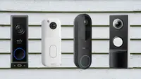 Four video doorbells sit on a house clapboard