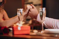 Couple holding hands with champagne